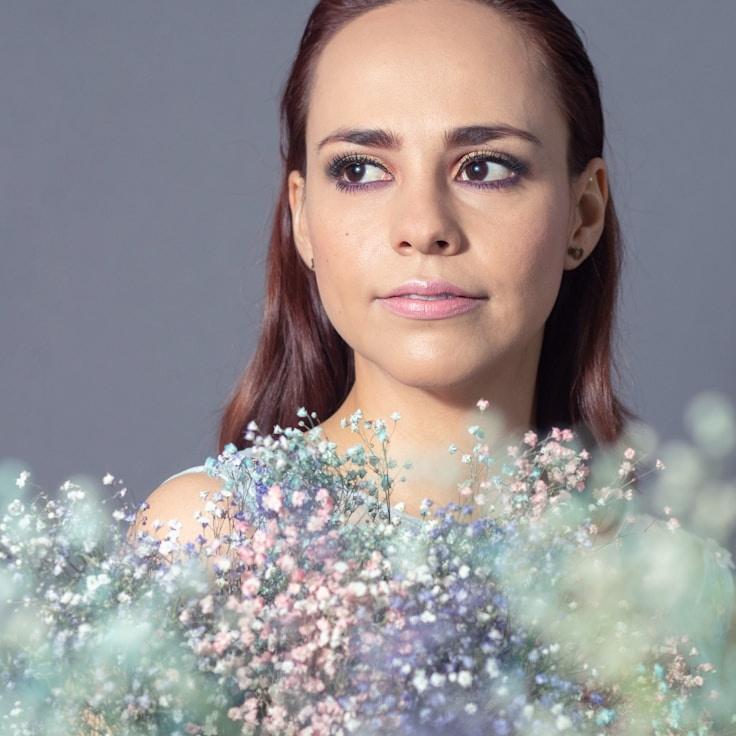 Aria Patel, Lead Design Strategist at BrightForestUnion, reviewing corporate floral arrangements